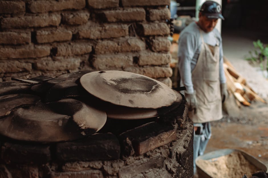 Rustic pottery workshop featuring clay pots being crafted by a skilled artisan.